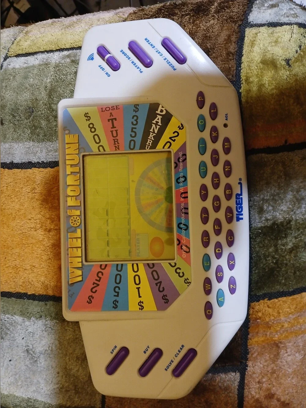 Tiger Electronics Wheel of Fortune Handheld Game - White with Purple Keys